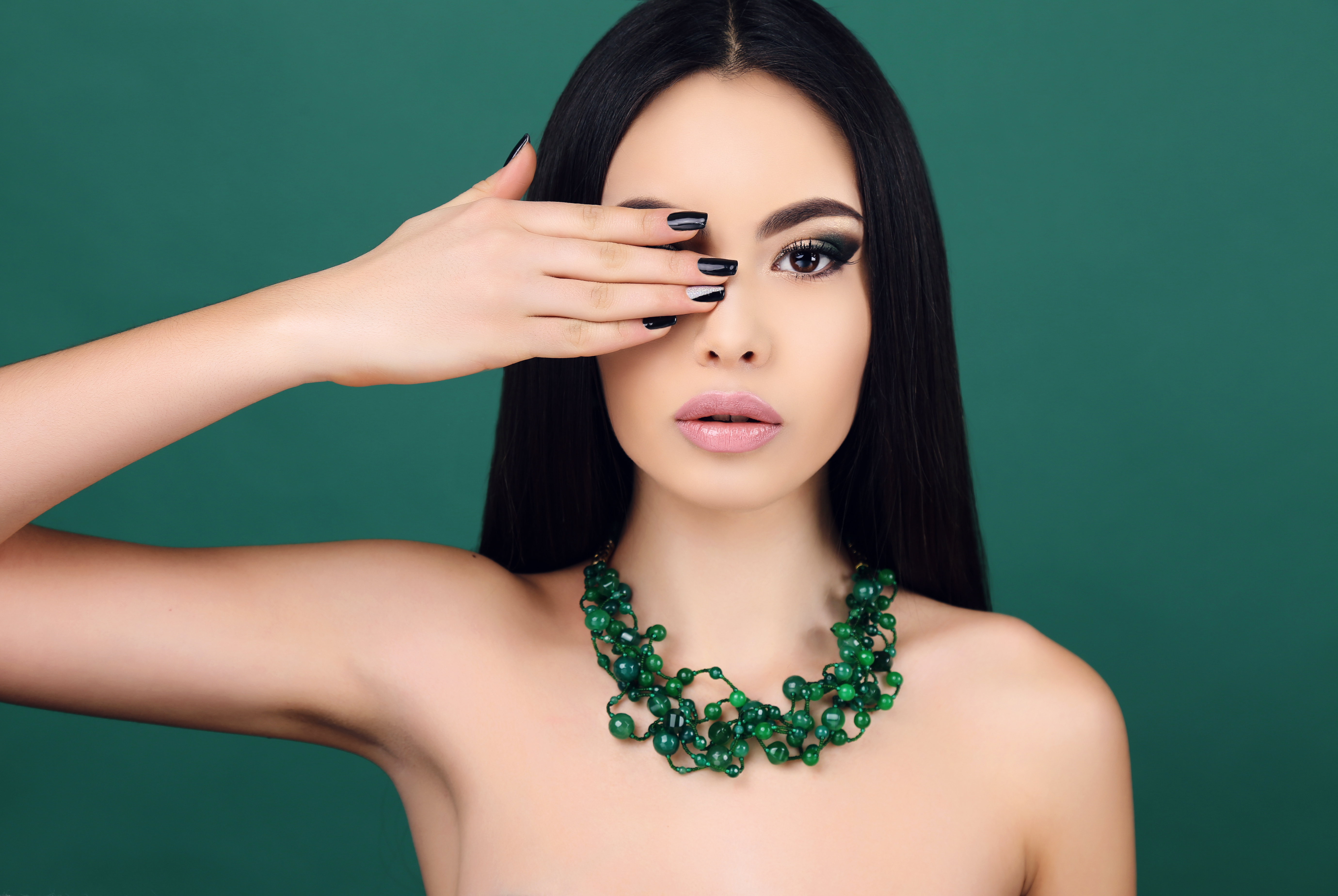 fashion portrait of beautiful sensual woman with dark straight hair with bright makeup and necklace