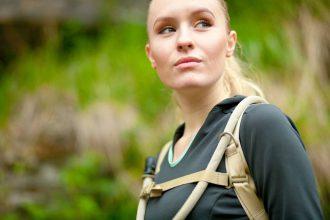 outdoor portrait of young beautiful woman while hiking