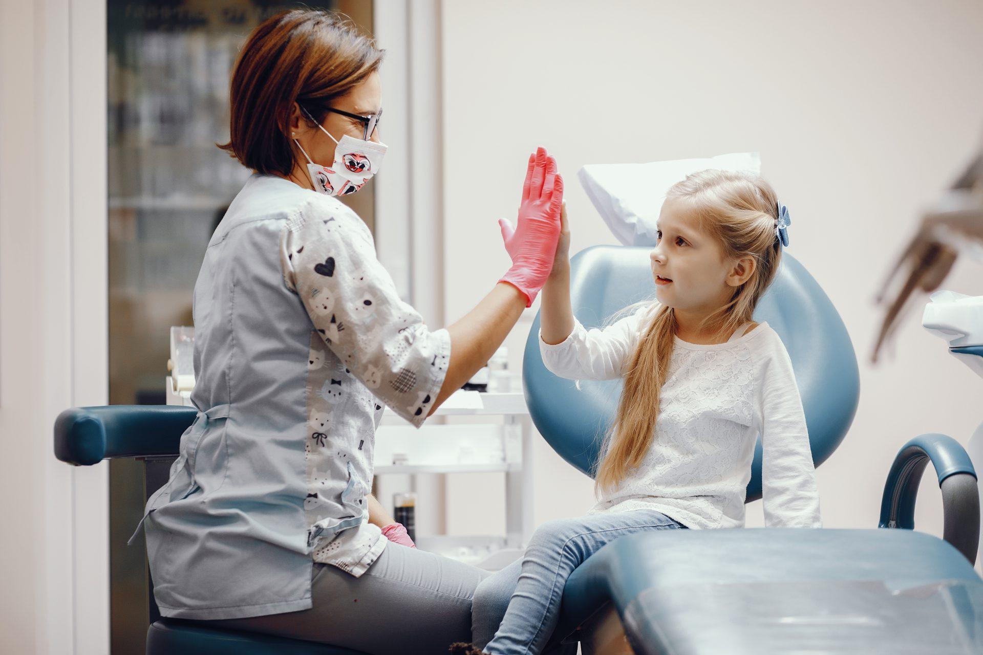 cute little girl sitting dentist s office