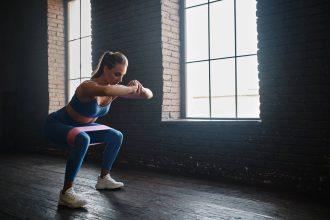 Crossfit healthy concept. Woman wearing sport clothing using resistance band