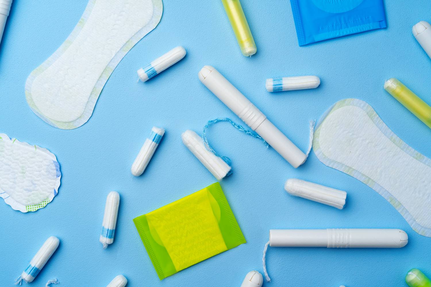Female hygienic pad and tampons on blue background